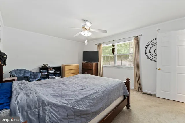 a bedroom with two beds and a chandelier