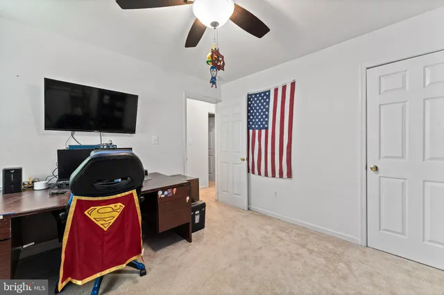 a bedroom with bed and flat screen tv