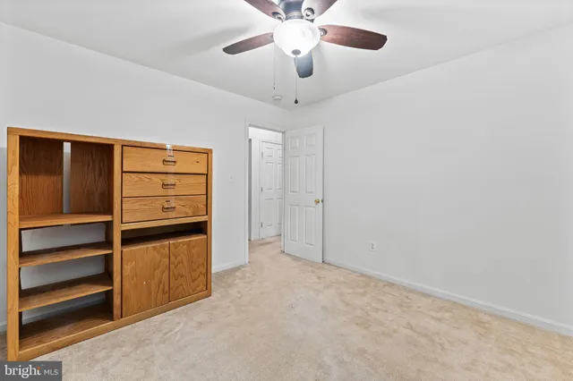 a view of an empty room with a cabinet