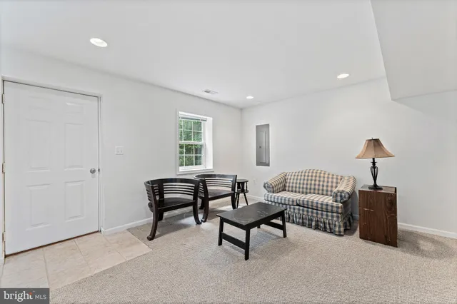 a living room with furniture and a lamp