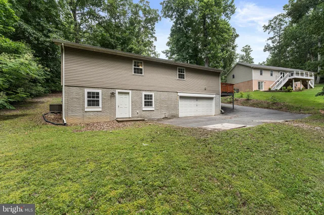 a house with green field in front of it