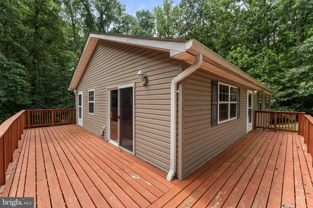 a view of backyard with a deck