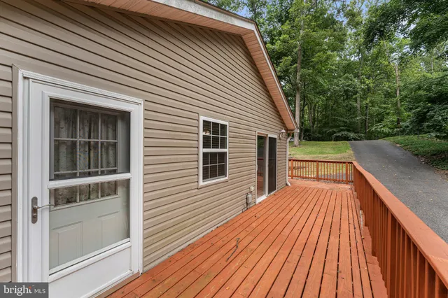 a view of backyard with a deck