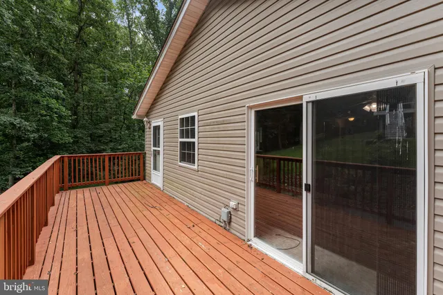 a view of backyard with a deck