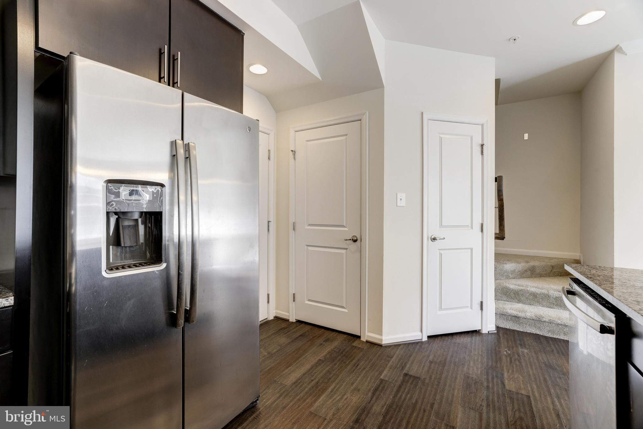 13660 Endeavour Drive, Unit 20C Herndon, VA 20171 - Photo 11 of 35 a view of a refrigerator in kitchen and wooden floor