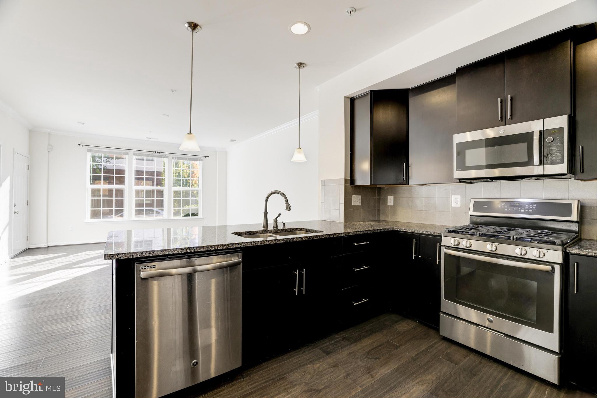 13660 Endeavour Drive, Unit 20C Herndon, VA 20171 - Photo 12 of 35 a kitchen with a sink stove and microwave