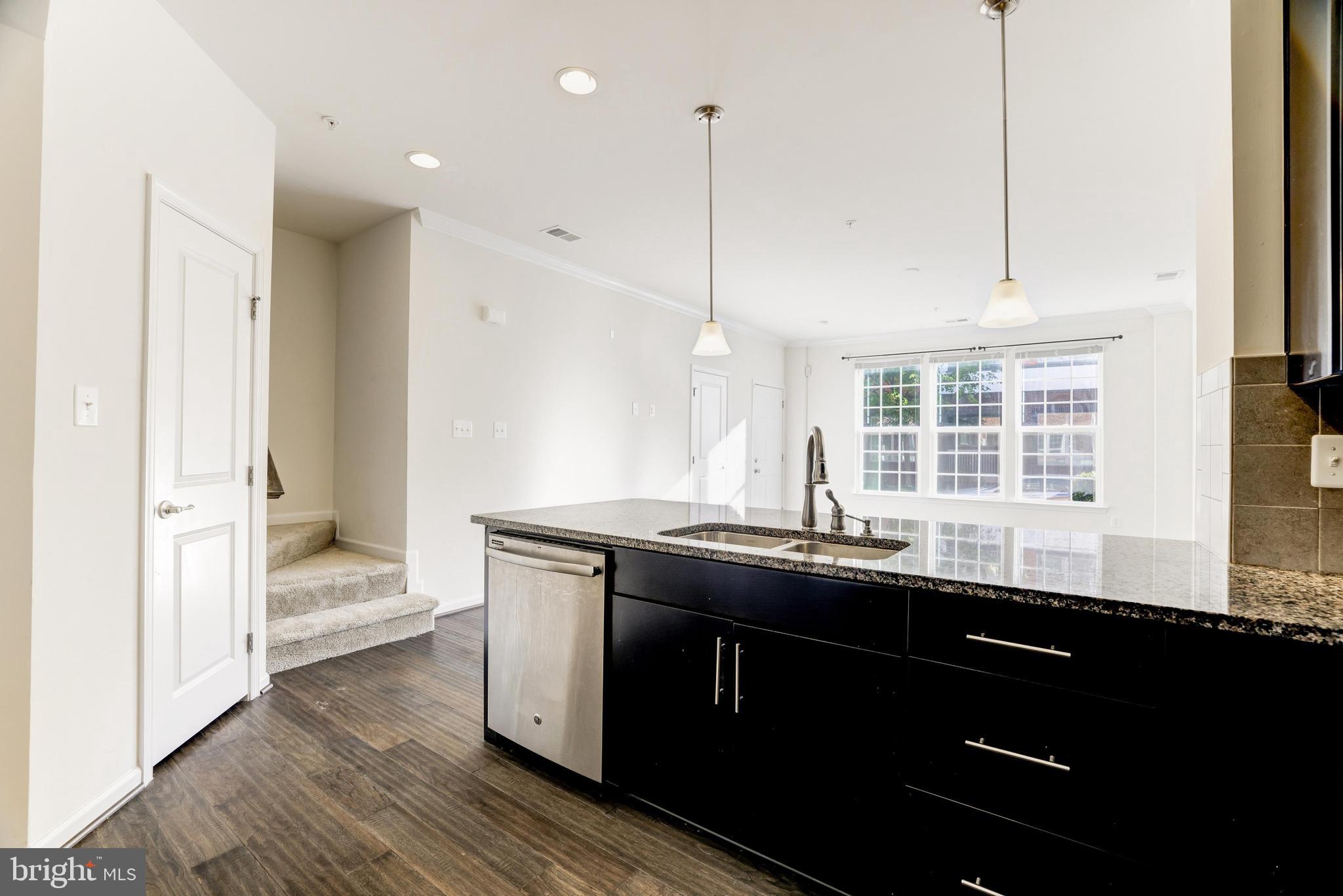 13660 Endeavour Drive, Unit 20C Herndon, VA 20171 - Photo 13 of 35 a kitchen with a sink stove and wooden floor