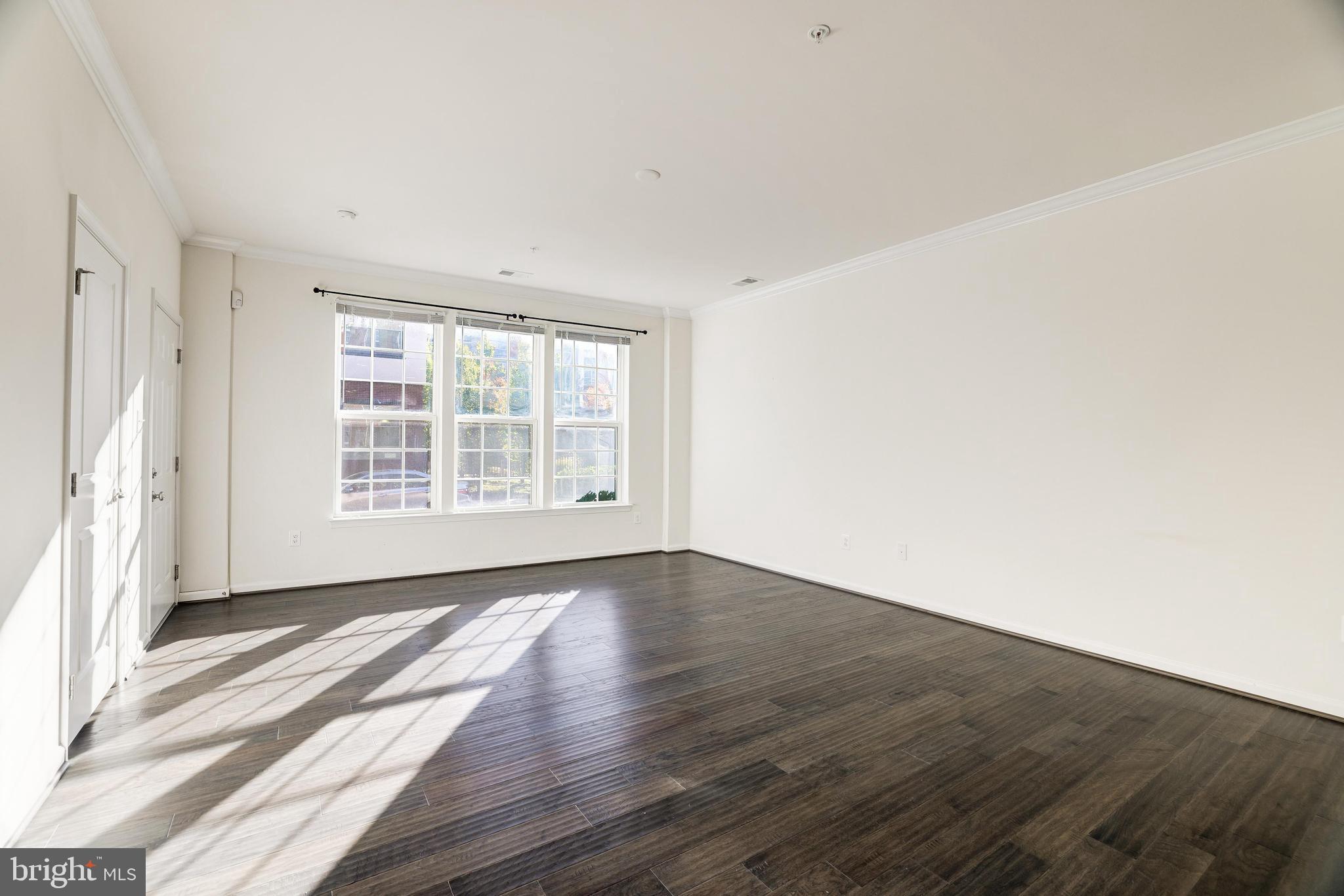 13660 Endeavour Drive, Unit 20C Herndon, VA 20171 - Photo 14 of 35 an empty room with wooden floor and windows
