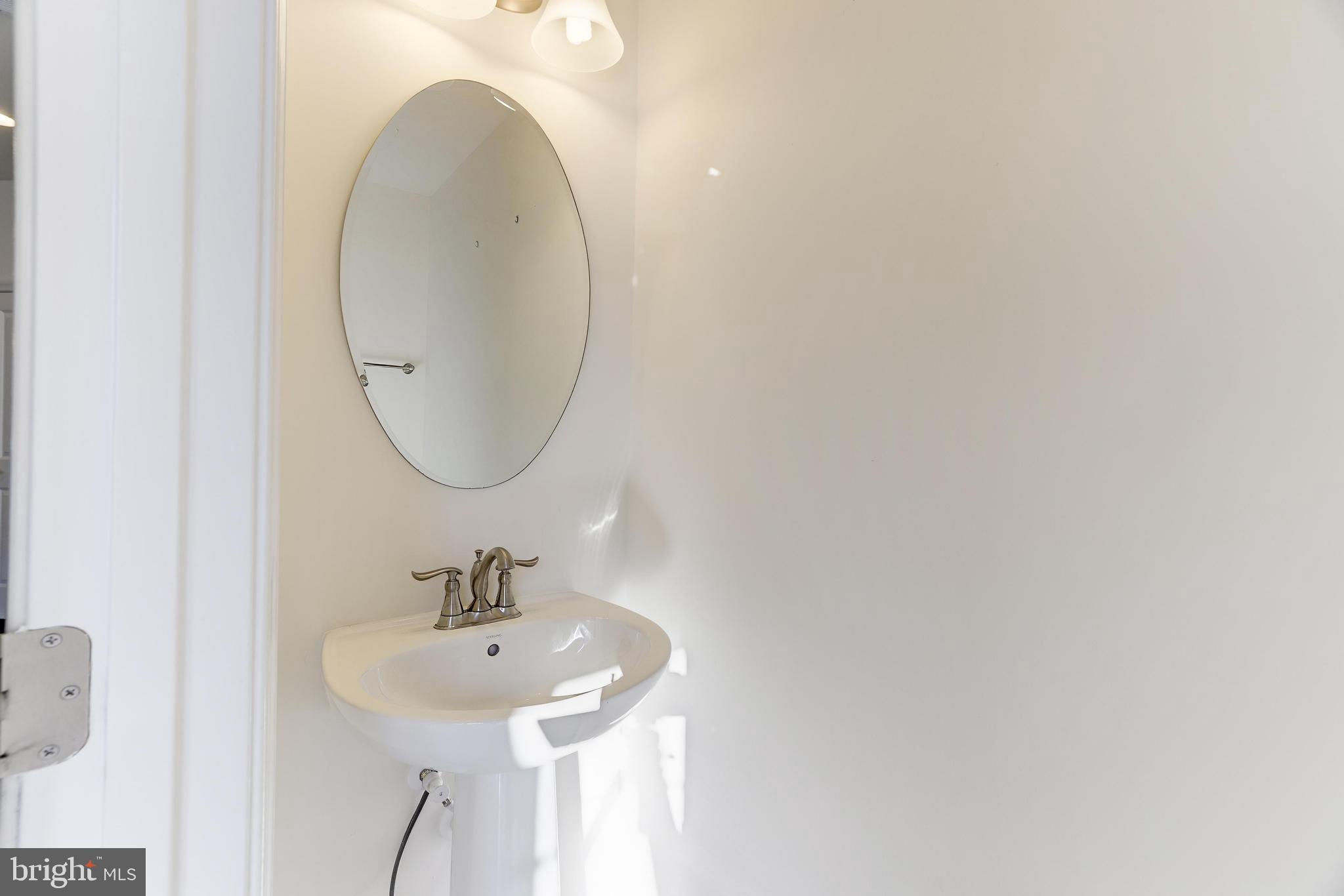 13660 Endeavour Drive, Unit 20C Herndon, VA 20171 - Photo 16 of 35 a bathroom with a sink and a mirror