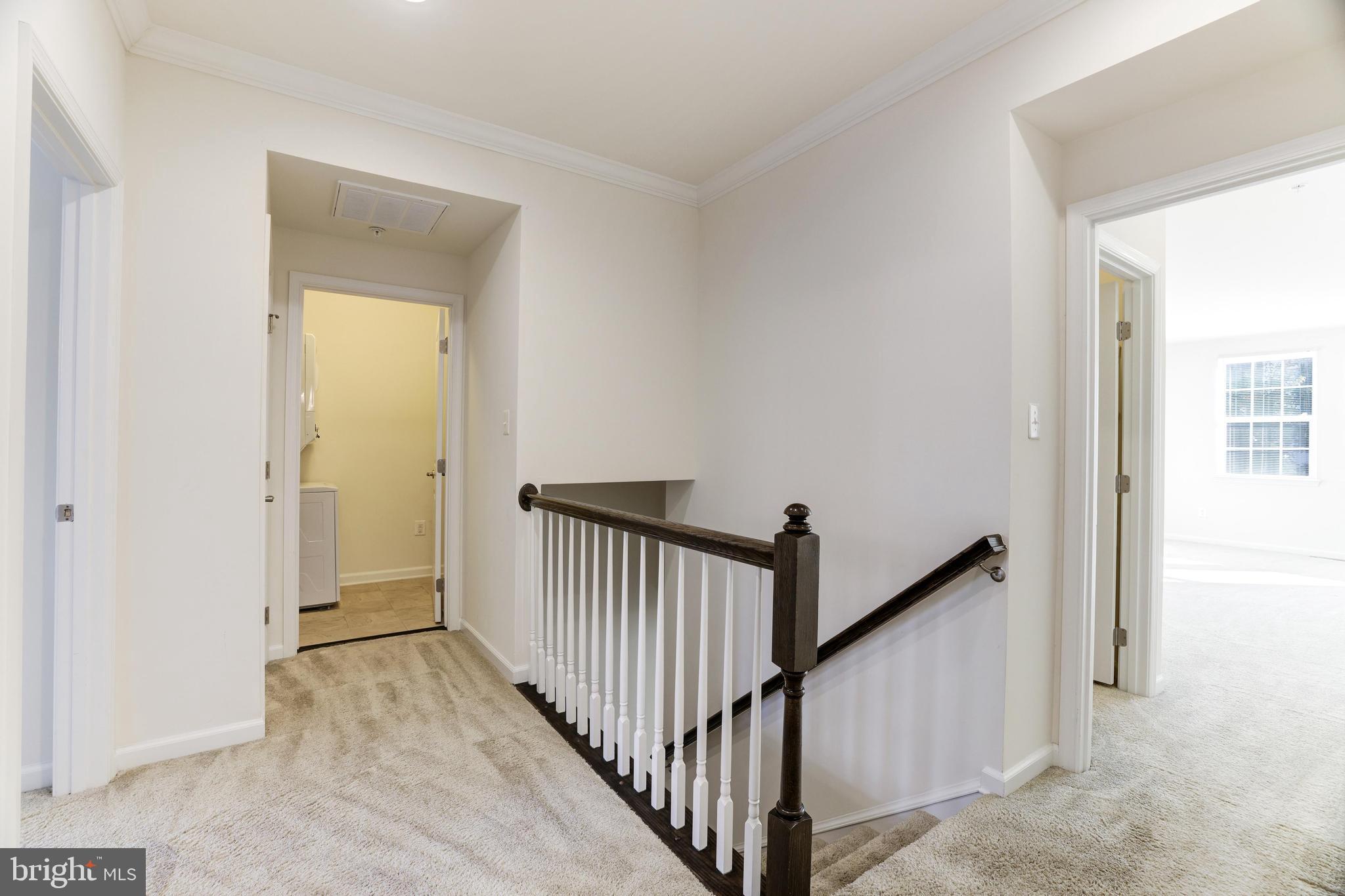 13660 Endeavour Drive, Unit 20C Herndon, VA 20171 - Photo 17 of 35 a view of a hallway with a window and stairs