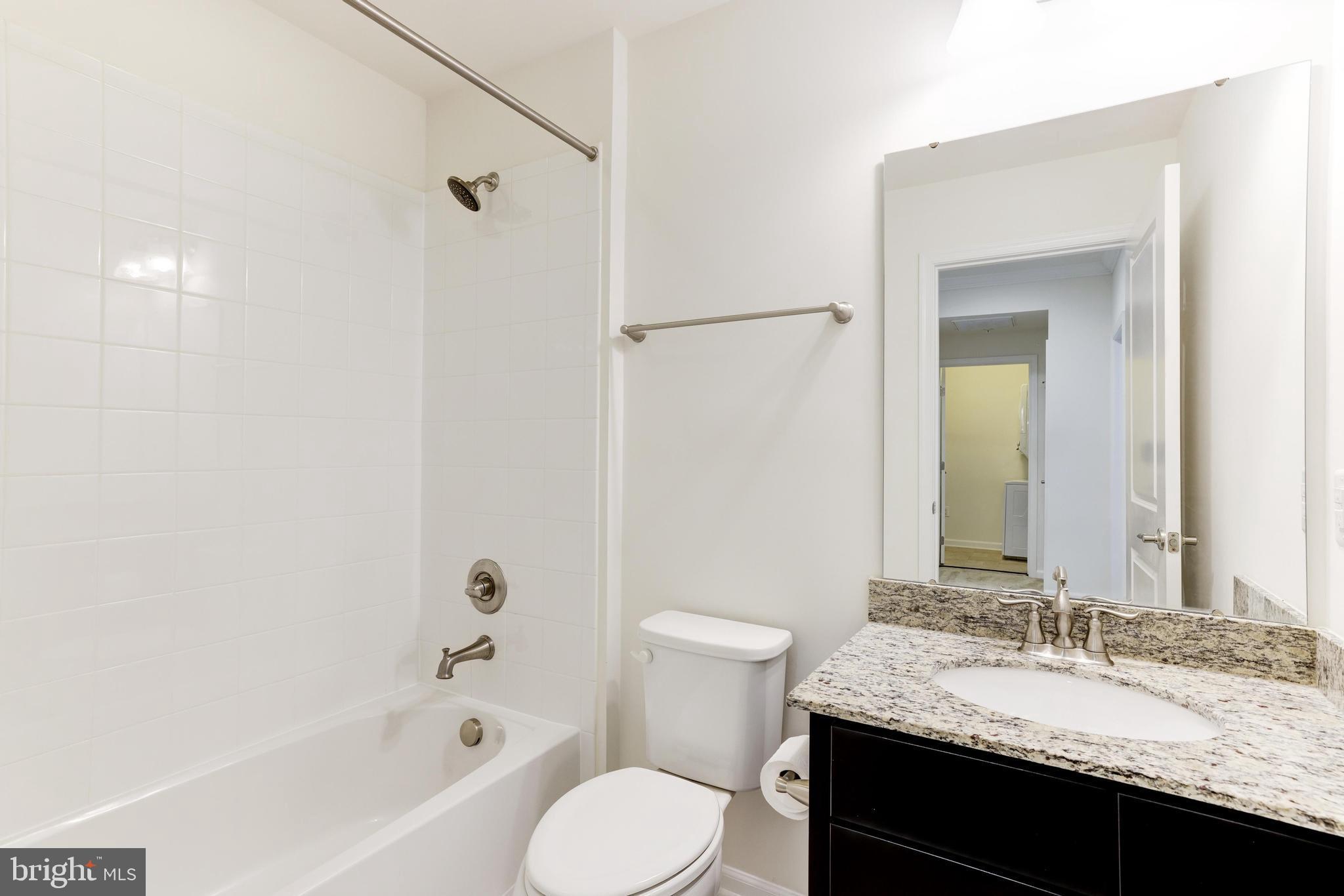 13660 Endeavour Drive, Unit 20C Herndon, VA 20171 - Photo 30 of 35 a bathroom with a granite countertop sink toilet and shower
