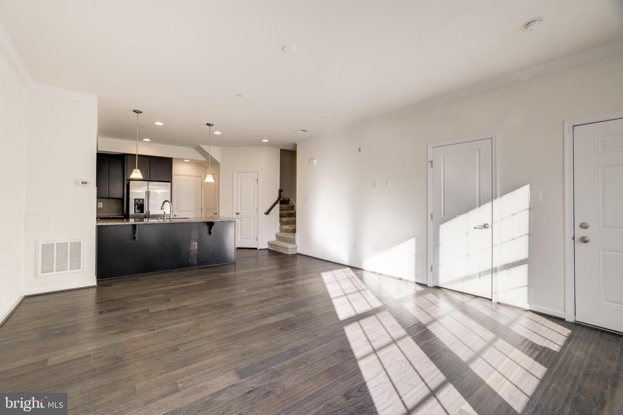 13660 Endeavour Drive, Unit 20C Herndon, VA 20171 - Photo 7 of 35 a view of a kitchen with kitchen island wooden floor stainless steel appliances and cabinets
