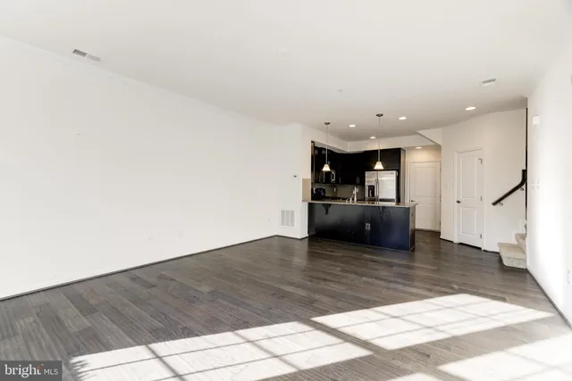 a view of a kitchen with a sink and a refrigerator