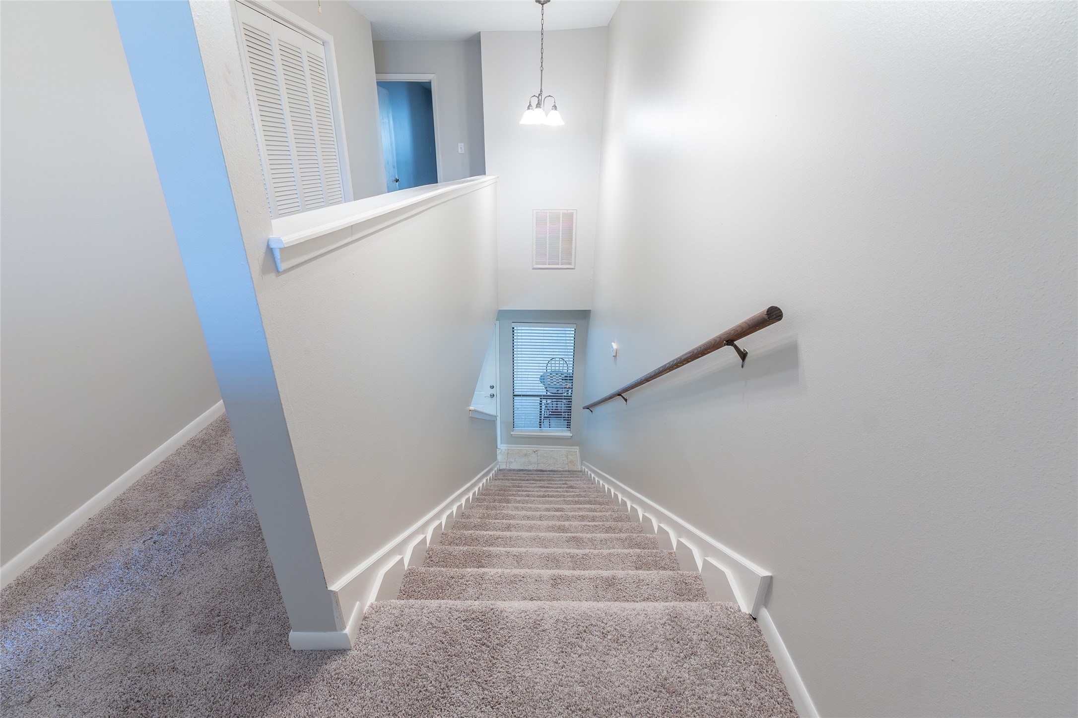 38 Regency Point Montgomery, TX 77356 - Photo 19 of 49 on the left: upstairs hallway, laundry room, door of third bedroom, on the right: stairs, door to flex room at the bottom of the stairs.