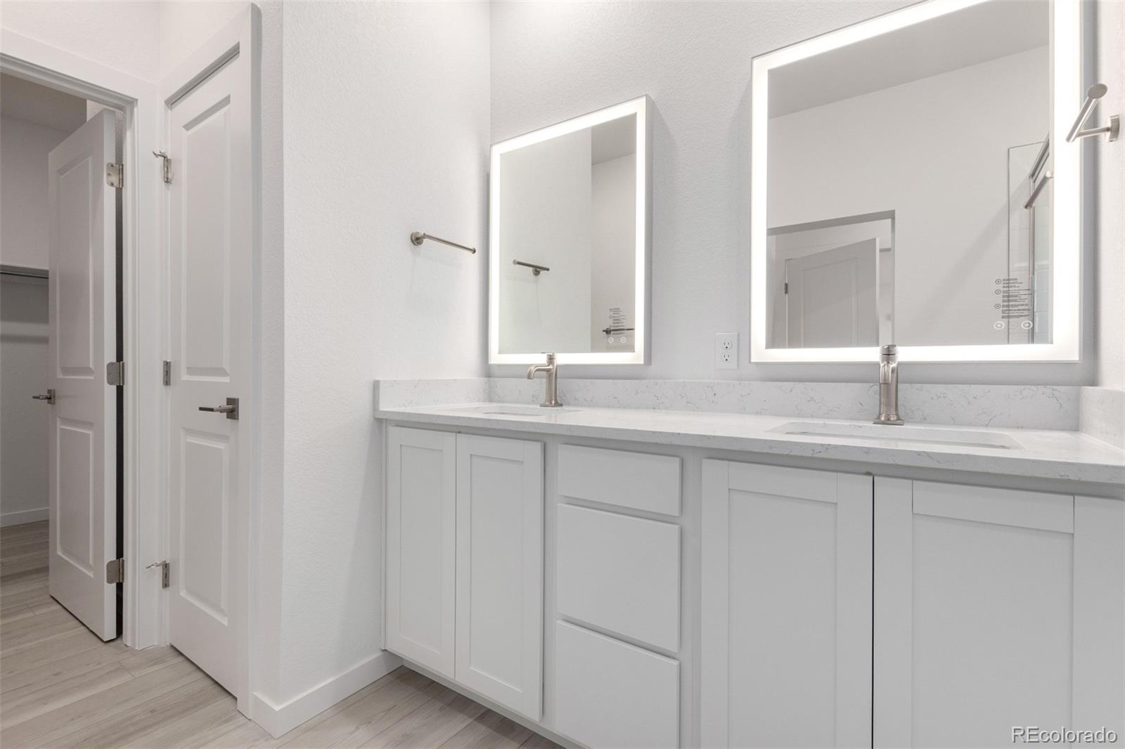 6153 North Ceylon Street, Unit 303 Denver, CO 80249 - Photo 11 of 21 a bathroom with double sink and a mirror