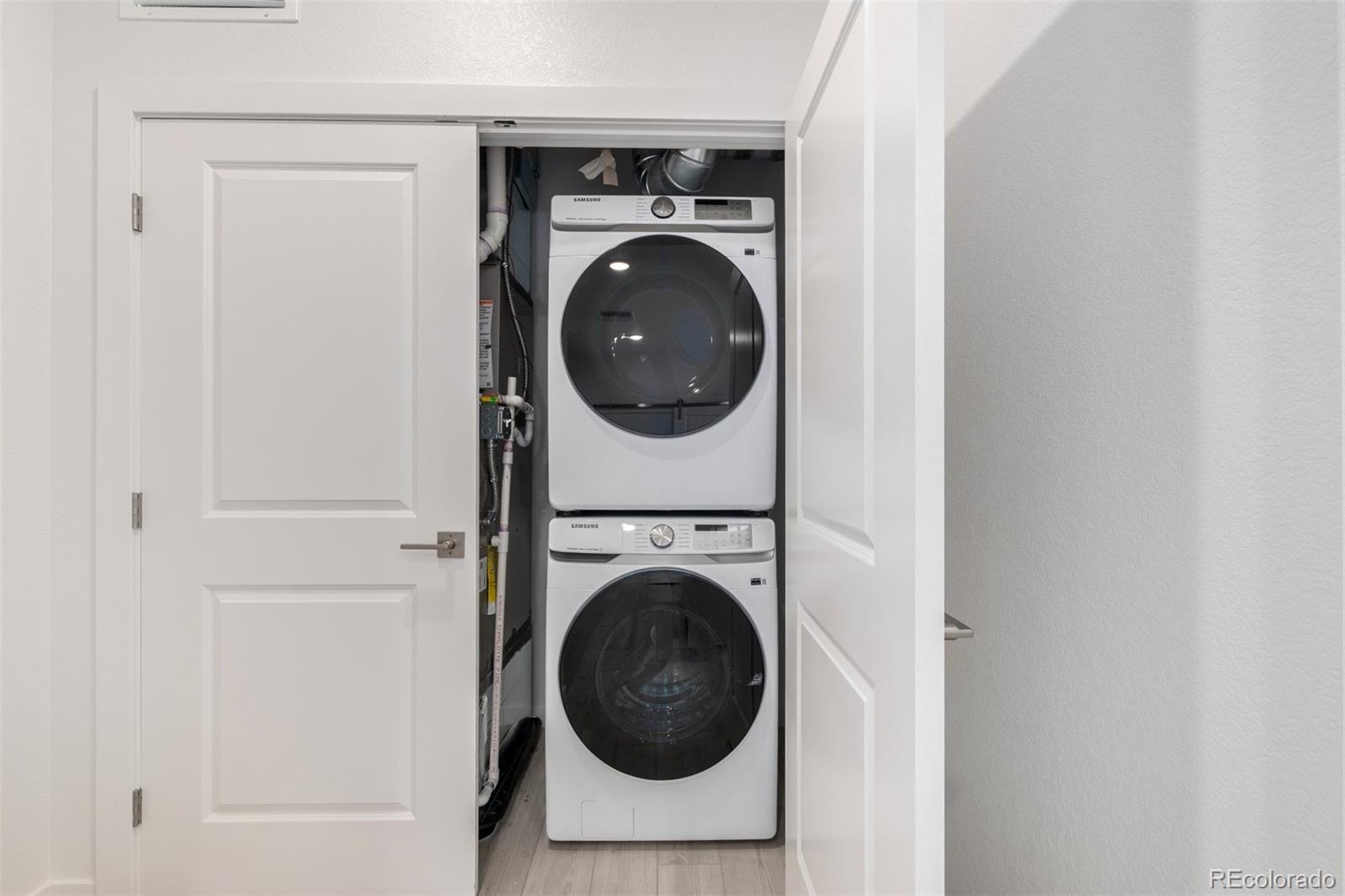6153 North Ceylon Street, Unit 303 Denver, CO 80249 - Photo 17 of 21 a utility room with dryer and washer