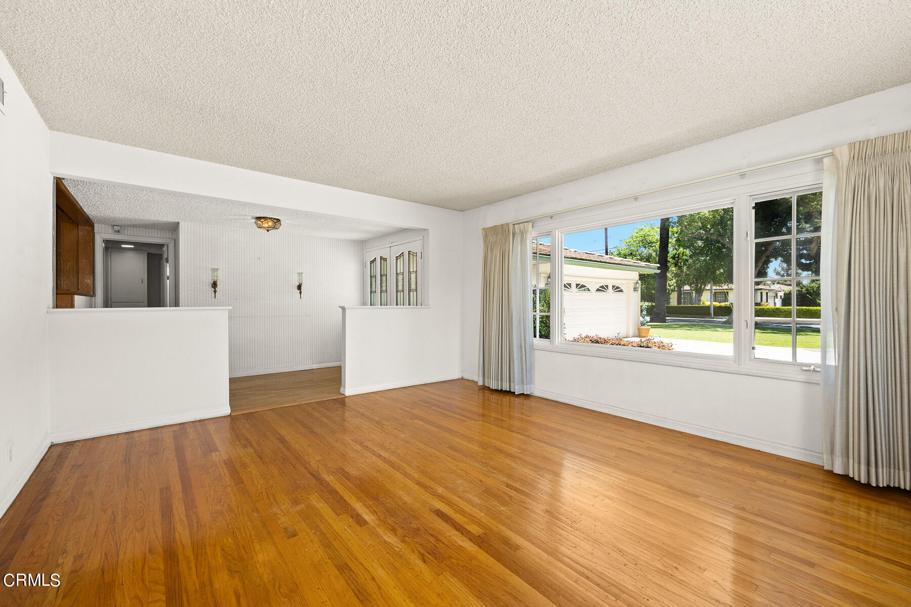 1321 South Eighth Avenue Arcadia, CA 91006 - Photo 7 of 47 a view of an empty room with wooden floor and a window