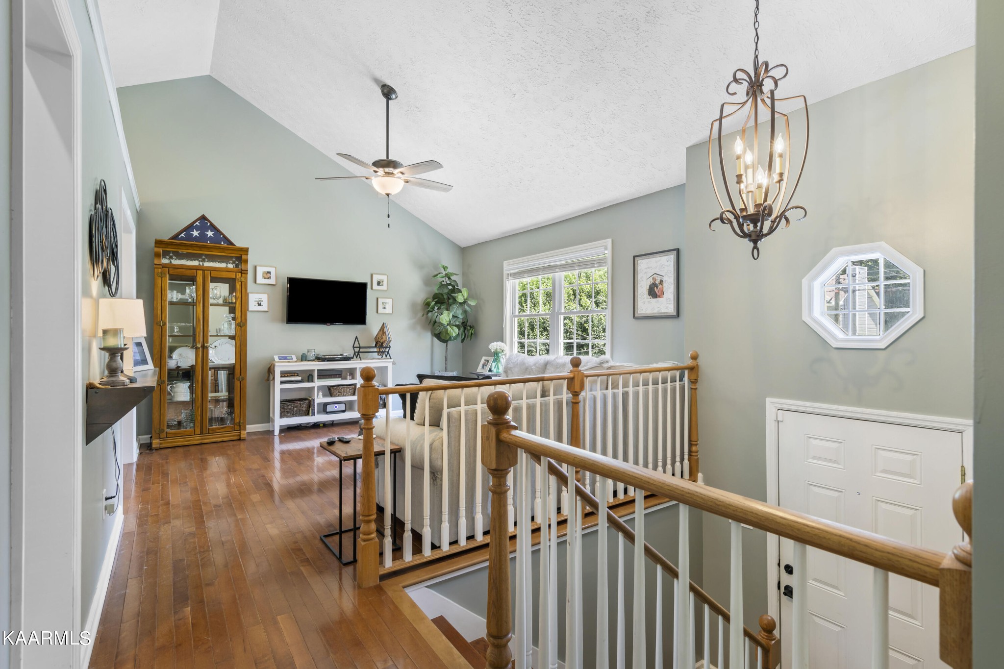 3909 Abercorn Road Knoxville, TN 37921 - Photo 16 of 18 a view of a livingroom with furniture wooden floor a ceiling fan and windows