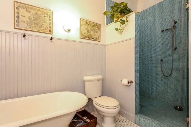 a white toilet sitting next to a bathroom sink