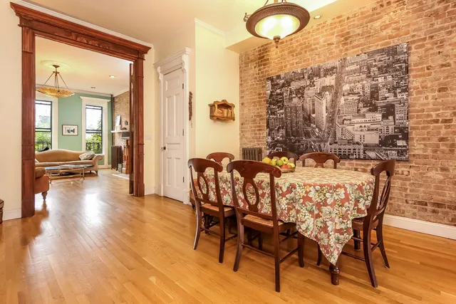 a kitchen with cabinets and wooden floor