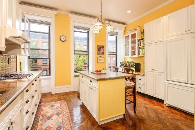 a kitchen with counter top space and windows
