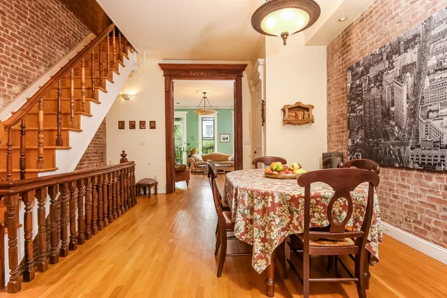 a bedroom with a bed dresser and a fireplace
