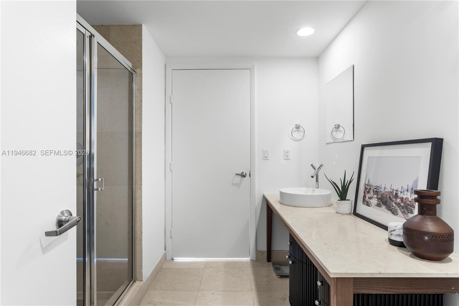 465 Brickell Avenue, Unit 5505 Miami, FL 33131 - Photo 15 of 25 a bathroom with a granite countertop sink and a mirror