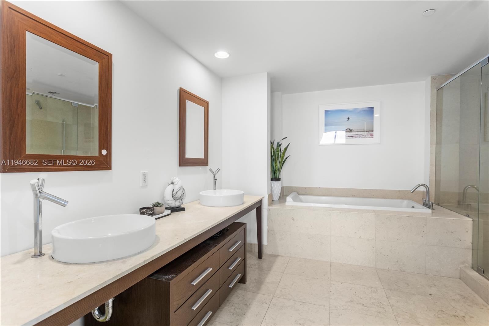 465 Brickell Avenue, Unit 5505 Miami, FL 33131 - Photo 18 of 25 a bathroom with a granite countertop bathtub sink and mirror