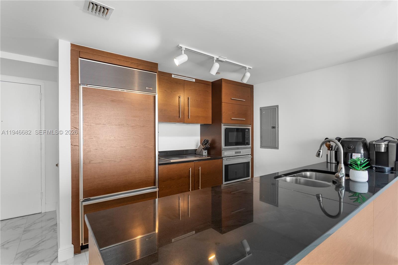 465 Brickell Avenue, Unit 5505 Miami, FL 33131 - Photo 2 of 25 a kitchen with stainless steel appliances granite countertop a refrigerator and a sink