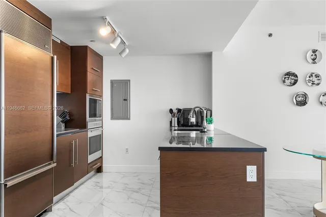 a kitchen with stainless steel appliances granite countertop a refrigerator and a stove