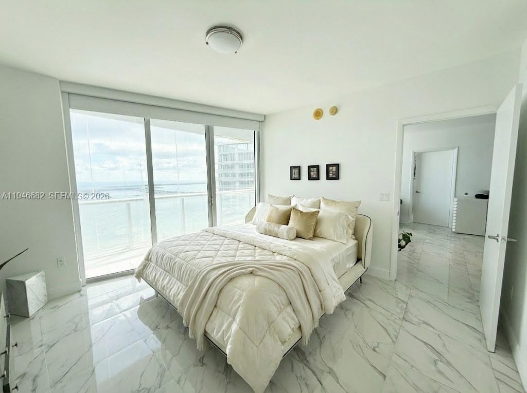465 Brickell Avenue, Unit 5505 Miami, FL 33131 - Photo 4 of 8 a bedroom with a bed and a large window