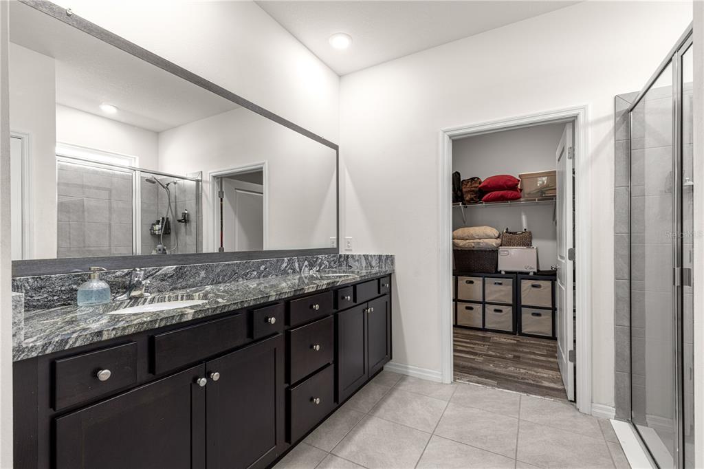 6233 Southwest 89th St Road Ocala, FL 34476 - Photo 19 of 39 a bathroom with a granite countertop sink and a mirror