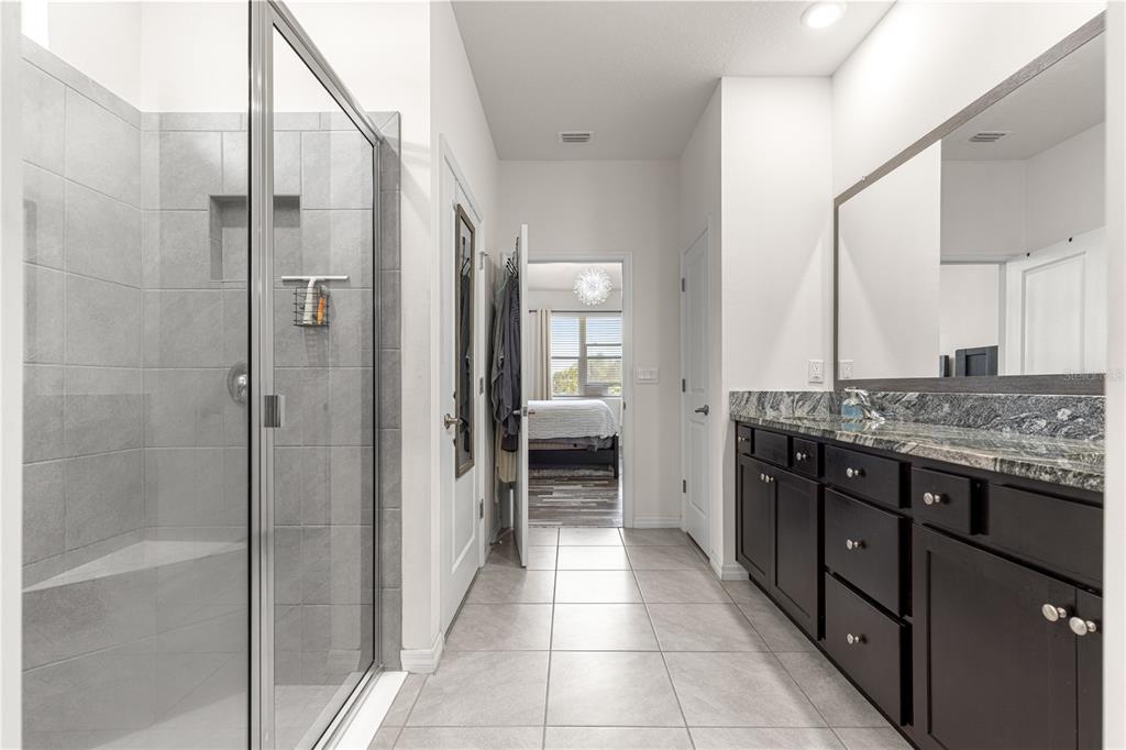 6233 Southwest 89th St Road Ocala, FL 34476 - Photo 20 of 39 a bathroom with a granite countertop sink shower and a mirror