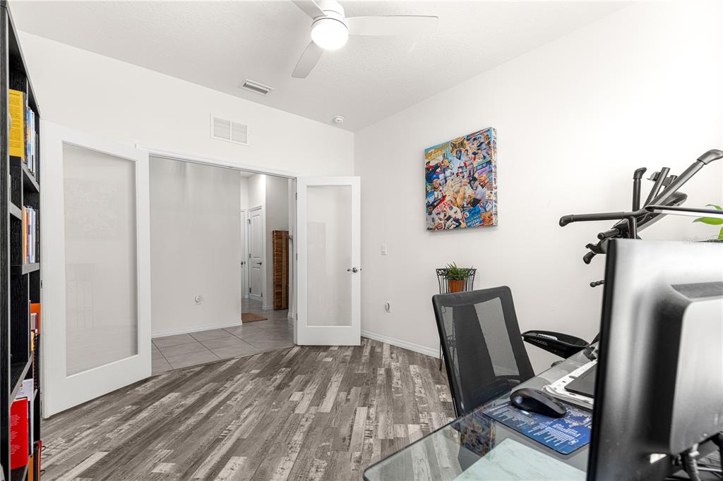 6233 Southwest 89th St Road Ocala, FL 34476 - Photo 23 of 39 a view of a hallway with workspace and wooden floor