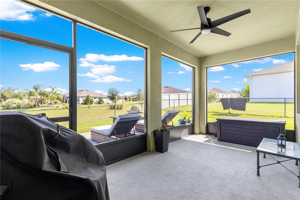 6233 Southwest 89th St Road Ocala, FL 34476 - Photo 31 of 39 a living room with furniture and a floor to ceiling window