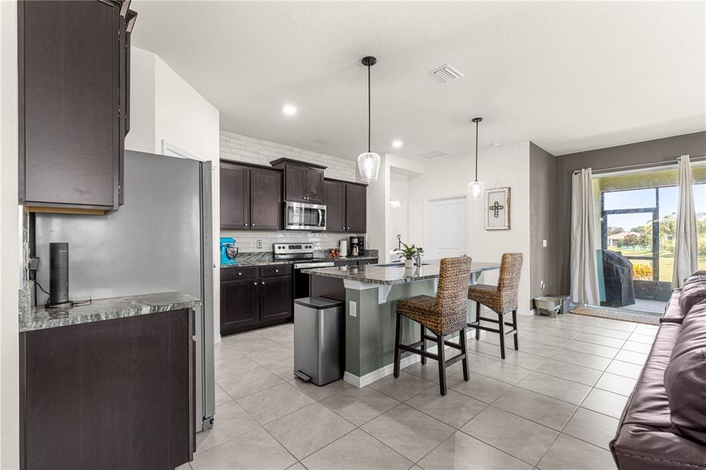6233 Southwest 89th St Road Ocala, FL 34476 - Photo 4 of 39 a large kitchen with a table and chairs