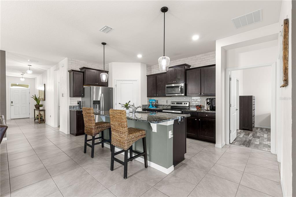 6233 Southwest 89th St Road Ocala, FL 34476 - Photo 5 of 39 a kitchen with a refrigerator a oven and a sink