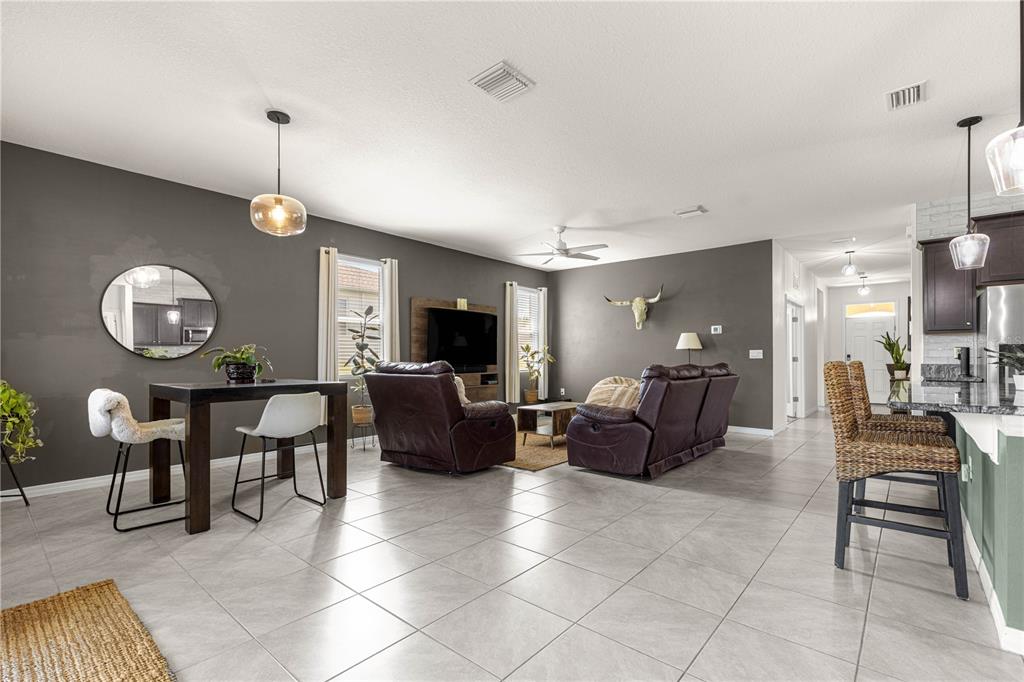 6233 Southwest 89th St Road Ocala, FL 34476 - Photo 9 of 39 a living room with furniture a dining table and a piano
