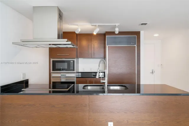 a kitchen with a sink cabinets and window