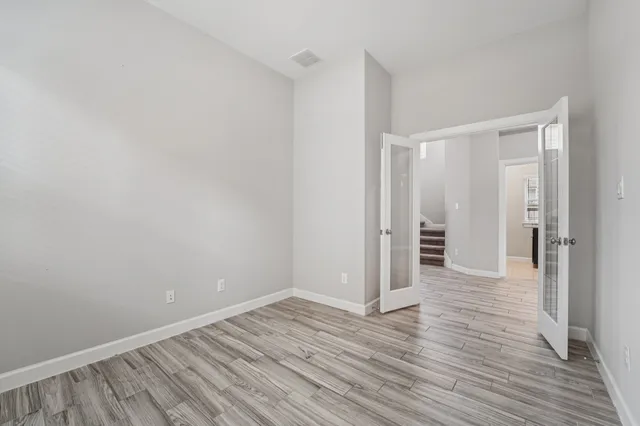 a view of a room with wooden floor and window