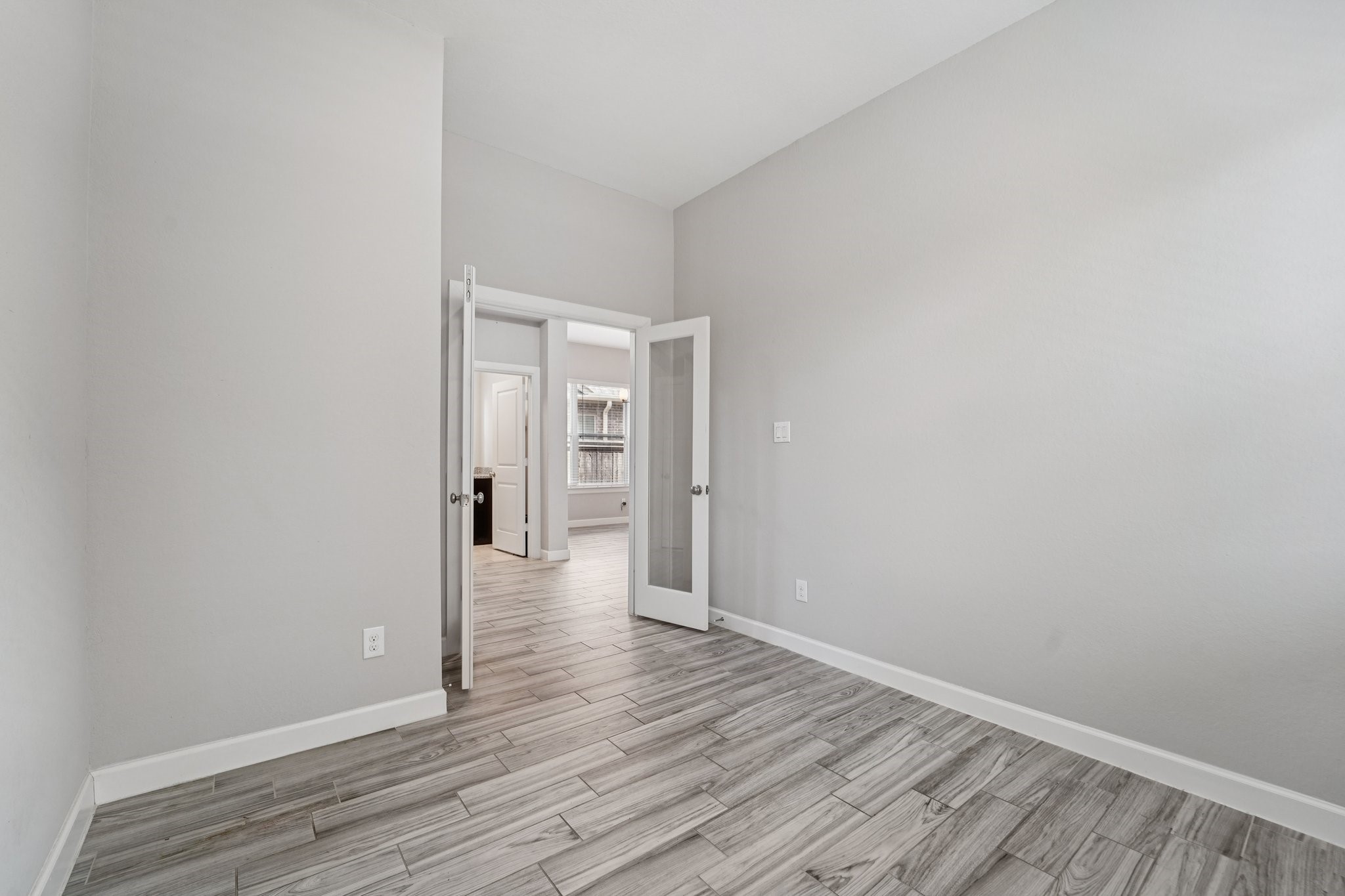 19751 Shinnery Ridge Court Cypress, TX 77433 - Photo 18 of 43 a view of an empty room with wooden floor