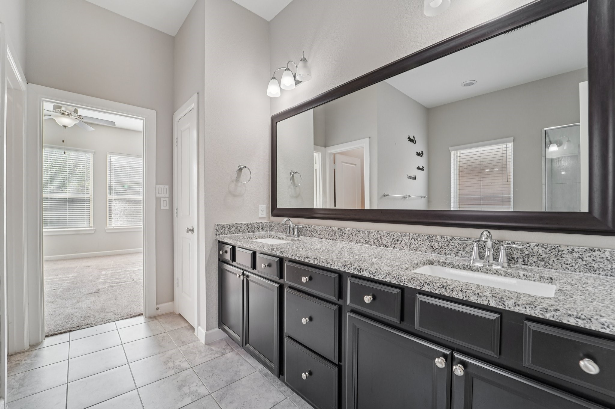 19751 Shinnery Ridge Court Cypress, TX 77433 - Photo 21 of 43 a bathroom with a granite countertop sink and a mirror