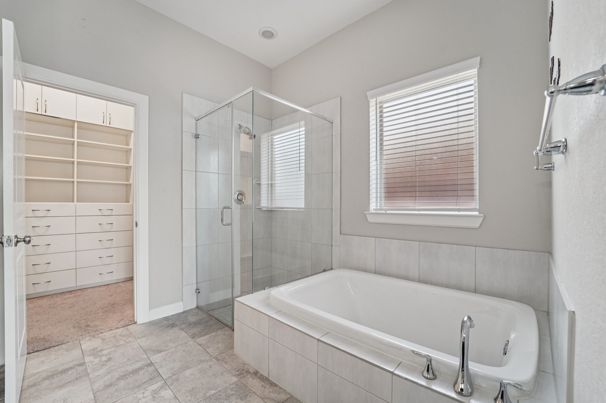 19751 Shinnery Ridge Court Cypress, TX 77433 - Photo 23 of 43 a bathroom with a tub a window and a glass door shower