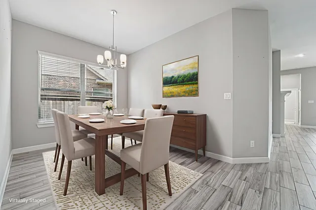 a view of a dining room with furniture window and wooden floor