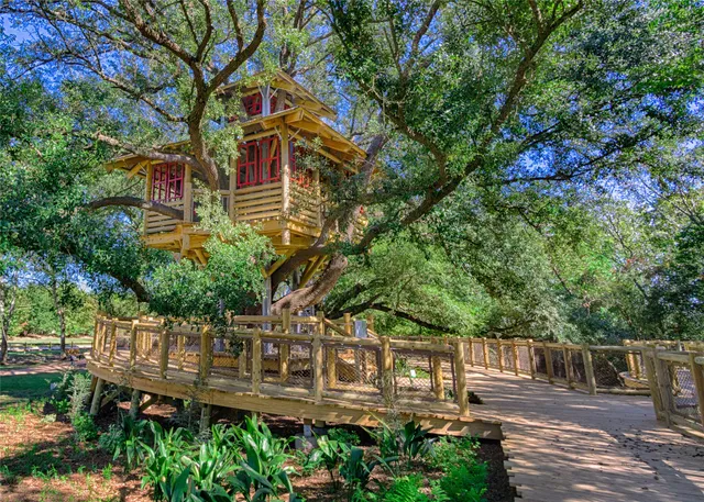 a view of a house with a tree in front