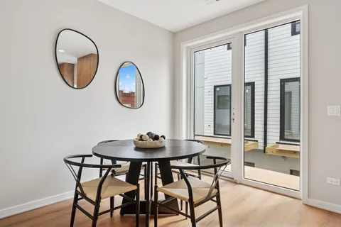 a dining room with furniture and a mirror