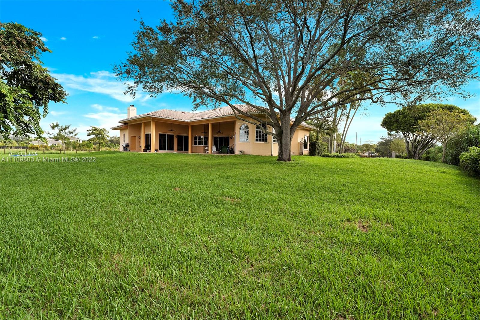 5879 Southwest 178th Avenue Southwest Ranches, FL 33331 - Photo 8 of 27 a front view of a house with a garden