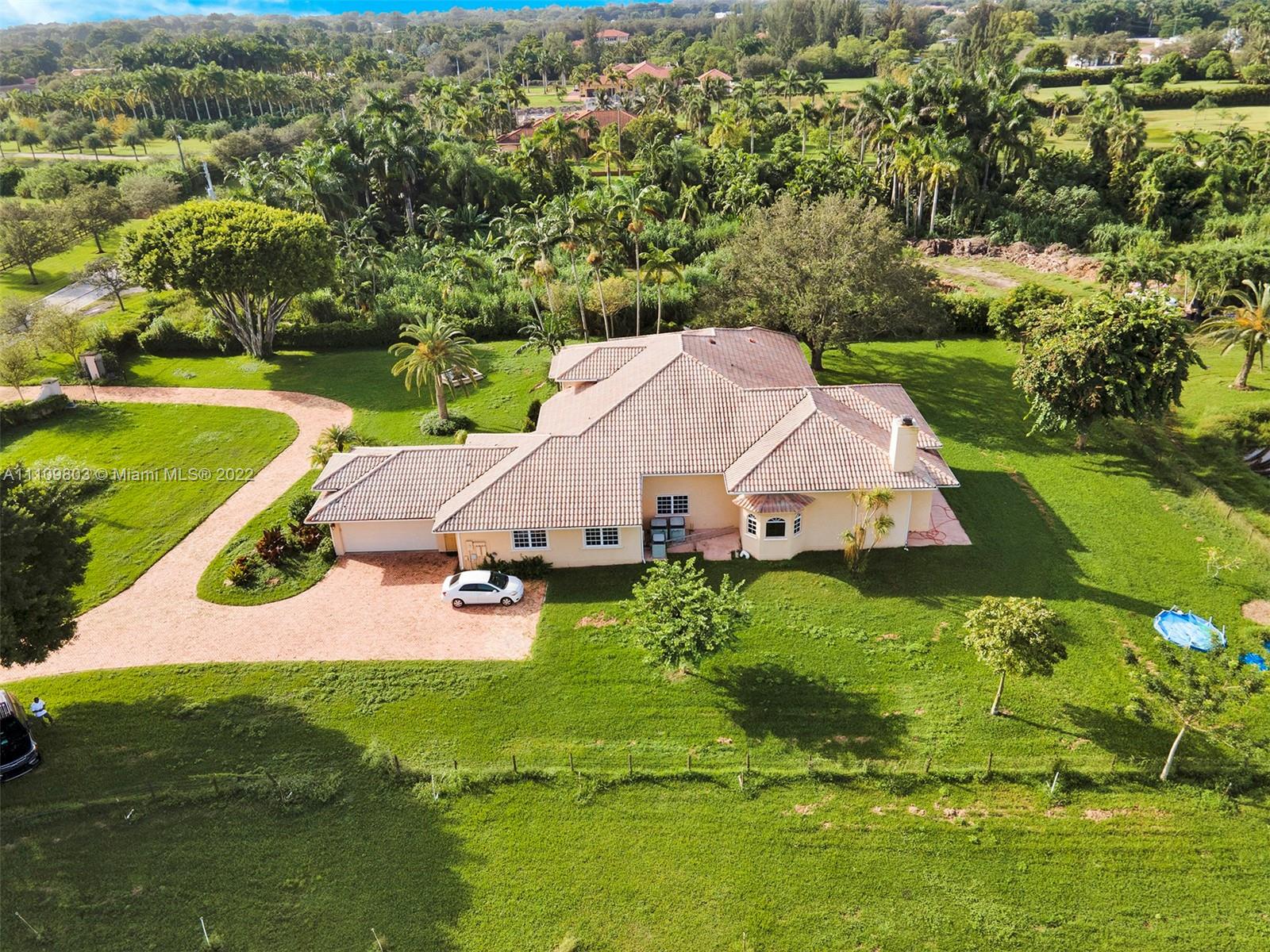 5879 Southwest 178th Avenue Southwest Ranches, FL 33331 - Photo 10 of 27 an aerial view of a house with swimming pool a yard and lake view
