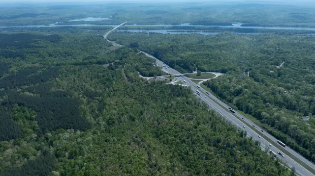 a view of a field of grass and trees
