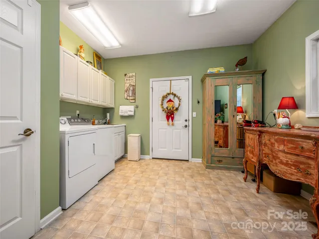 a kitchen with stainless steel appliances granite countertop a stove top oven a sink dishwasher and a table with chairs